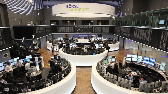 This file photo taken on Dec. 30, 2016 shows traders at the German Stock Exchange in Frankfurt am Main, western Germany.