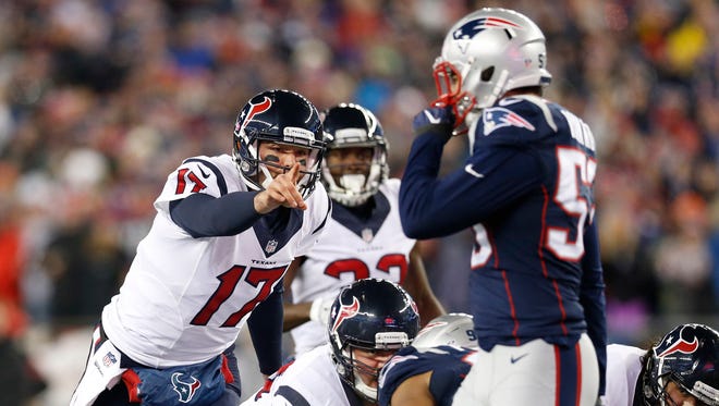 Houston Texans quarterback Brock Osweiler (17) gestures at the line against the New England Patriots during the first quarter in the AFC Divisional playoff game at Gillette Stadium.
