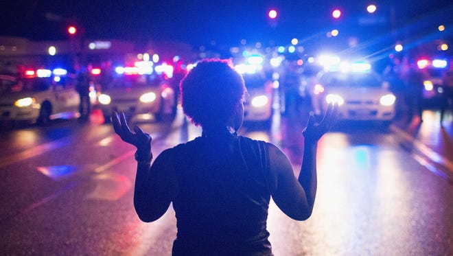 Demonstrators in Ferguson, Mo., on Aug. 9, 2015, mark the one-year anniversary of the shooting of Michael Brown.