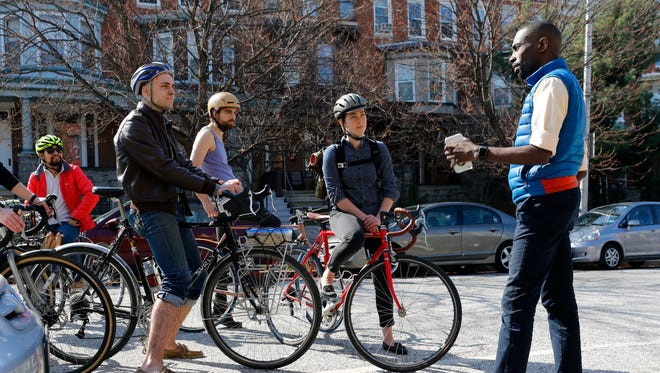 Former Black Lives Matter protester DeRay McKesson, right, chats with bicyclists during his unsuccessful bid for mayor of Baltimore.