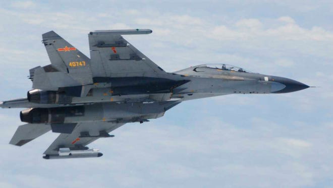 In this undated photo released by Japan's Ministry of Defense, a Chinese SU-27 fighter plane is shown in motion.