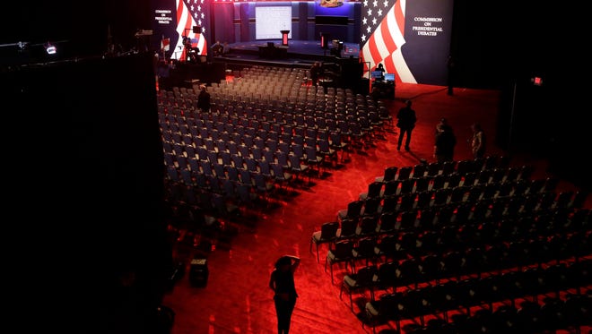 Workers prepare the stage for the presidential debate between Democratic presidential candidate Hillary Clinton and Republican presidential candidate Donald Trump at Hofstra University in Hempstead, N.Y.,
