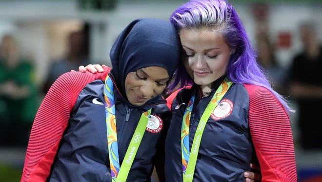 USA's Ibtihaj Muhammad (left) and Dagmara Wozniak  celebrate after winning a bronze medal in the team sabre competition.