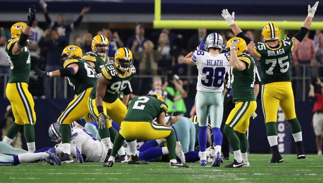 The Packers celebrate after Mason Crosby's game-winning field goal against the Cowboys.