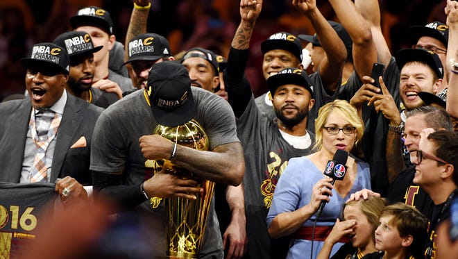 Cleveland Cavaliers forward LeBron James (23) celebrates with the Larry O'Brien Championship Trophy after beating the Golden State Warriors in game seven of the NBA Finals at Oracle Arena.