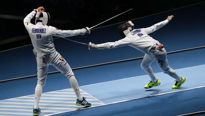 Silvio Fernandez of Venezuela competes against Alexandre Camargo of Brazil during the men's team epee fencing last 16 in the Rio 2016 Summer Olympic Games at Carioca Arena 3.