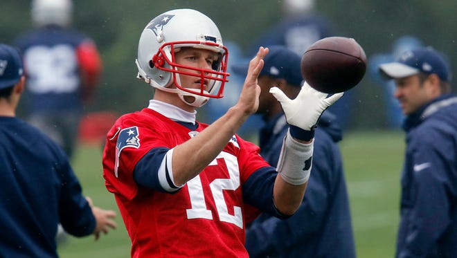 New England Patriots quarterback Tom Brady catches the ball during organized team activities Thursday, May 25, 2017, in Foxborough, Mass.