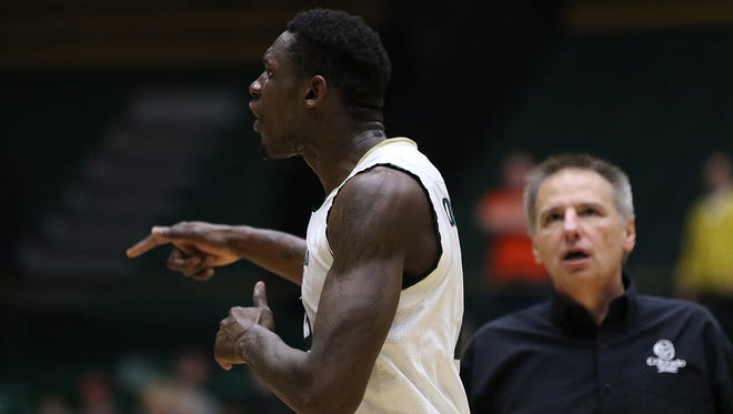 CSU basketball coach Larry Eustachy tries to calm down player Emmanuel Omogbo during a heated exchange between the Rams and New Mexico players near the end of Saturday's game at Moby Arena.