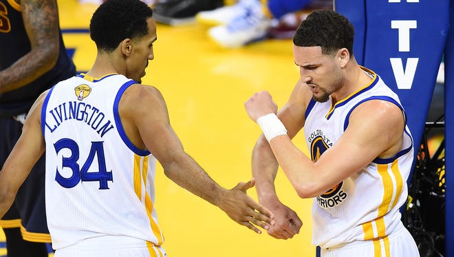 Golden State Warriors guard Shaun Livingston (34) and guard Klay Thompson (11) celebrate a scoring play against Cleveland Cavaliers during the second half in Game 2 of the NBA Finals.