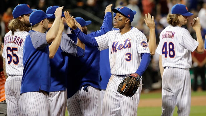 Mets' Curtis Granderson (3) celebrates with teammates after a baseball game against the Cubs on Wednesday, June 14, 2017, in New York. The Mets won 9-4.