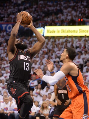 Houston Rockets guard James Harden (13) shoots the ball over Oklahoma City Thunder forward Andre Roberson (21) during the second quarter in game four of the first round of the 2017 NBA Playoffs at Chesapeake Energy Arena.