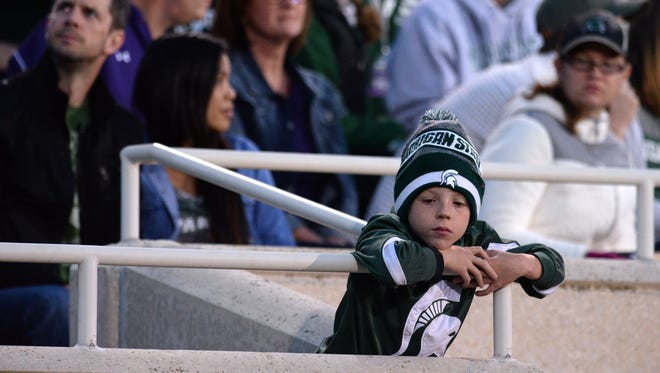 A young fan reacts during the game against Northwestern on Saturday, Oct. 15, 2016 at Spartan Stadium in East Lansing. Northwestern defeated MSU, 54-40.