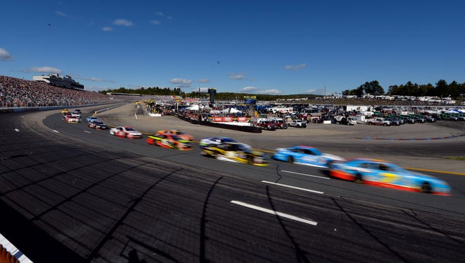 Round 1: Cars race around the 1-mile oval at New Hampshire Motor Speedway on Sept. 25.