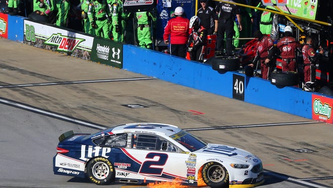 Round 2: Brad Keselowski drives to the garage as flames engulf his No. 2 Ford Sunday at Talladega Superspeedway. Keselowski finished 38th and was eliminated from the Chase.