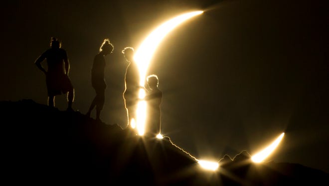 Hikers watched a partial solar eclipse in Phoenix in May 2012. The moon's silhouette blocked out about 83% of the sun's surface area in the area.