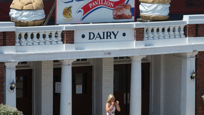 A woman exits the dairy building where cream puffs are made and sold at State Fair Park. The historic building needs renovations to make it more efficient.