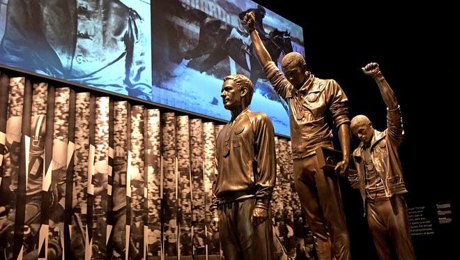 A life-size sculpture records the moment at the 1968 Olympics when Tommie Smith and John Carlos raised their fists in the air on the medal podium, seen here during the media preview for the Smithsonian's National Museum of African American History and Culture in Washington, on Sept. 15, 2016.