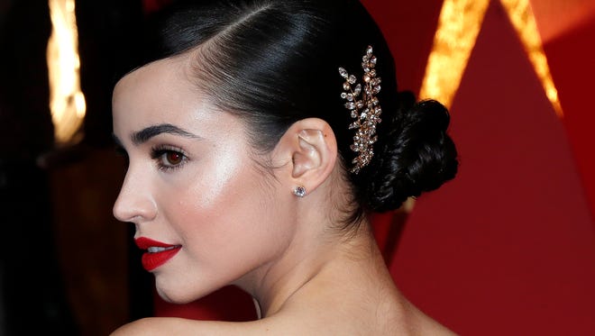 Sofia Carson channels pure sophistication with an updo and embellished clip, which perfectly paired with her Monique Lhuillier gown.