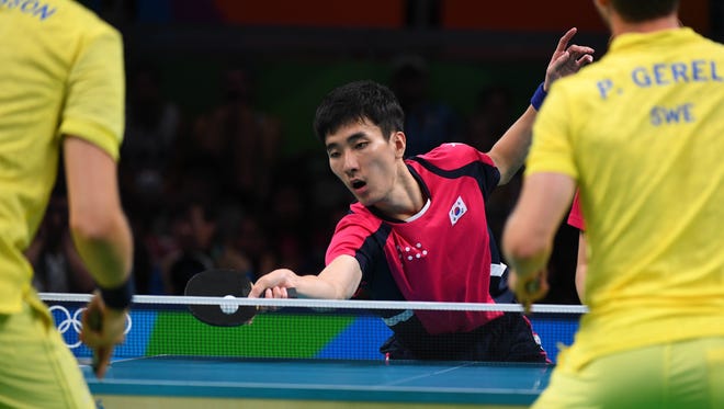 Sangsu Lee and Yougsik Jeoung of South Korea compete against Par Gerell and Mattias Karlsson of Sweden in a men's team table tennis match at Riocentro - Pavilion 3 during the Rio 2016 Summer Olympic Games.