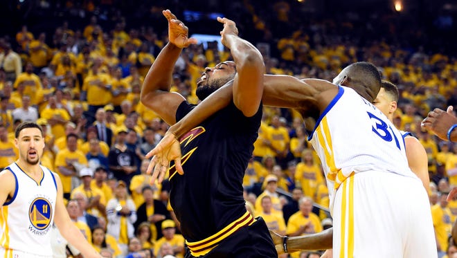 Golden State Warriors center Festus Ezeli (31) fouls Cleveland Cavaliers center Tristan Thompson (13) during the first quarter in Game 5 of the NBA Finals at Oracle Arena.