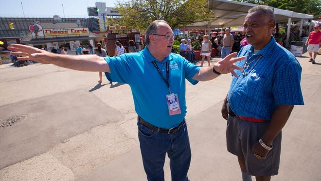 Wisconsin State Fair Park board chair John Yingling (left) gives directions to fairgoer Sam Julks at Wisconsin State Fair Park in West Allis.