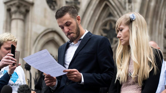 The parents of critically ill baby Charlie Gard, Chris Gard and Connie Yates, deliver a statement outside the High Court in London on July 24, 2017.