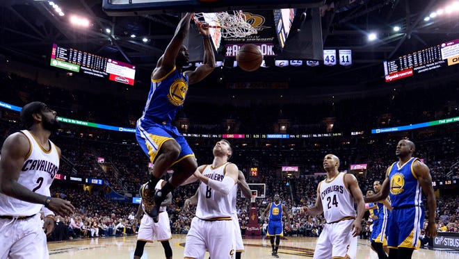 Golden State Warriors forward Harrison Barnes (40) dunks the ball against Cleveland Cavaliers guard Matthew Dellavedova (8) in Game 3 of the NBA Finals at Quicken Loans Arena.