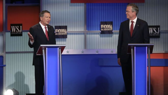 Kasich speaks alongside Jeb Bush at the Republican debate hosted by Fox Business and The Wall Street Journal on Nov. 10, 2015 in Milwaukee.