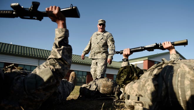 Army National Guard Sgt. 1st Class Daniel Ford shouts at Officer Candidates doing "Lines of Knowledge" drills during Phase One of Officer Candidate School and training at the Connecticut National Guard's 169th Regional Training Institute at Camp Niantic in East Lyme, Conn., July 22, 2015.