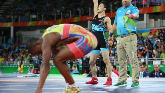Lumin Wang of China celebrates after defeating Andres Roberto Montano Arroyo of Ecuador during the men's greco roman 59g kg wrestling 1/8 finals in the Rio 2016 Summer Olympic Games at Carioca Arena 2.