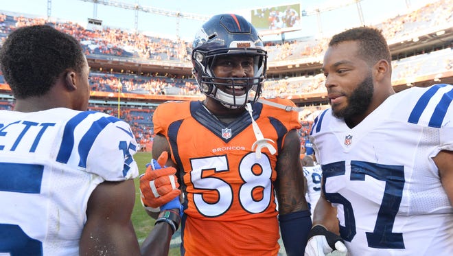Denver Broncos outside linebacker Von Miller (58) greets Indianapolis Colts wide receiver Phillip Dorsett (15) and inside linebacker Josh McNary (57) following the game at Sports Authority Field at Mile High.
