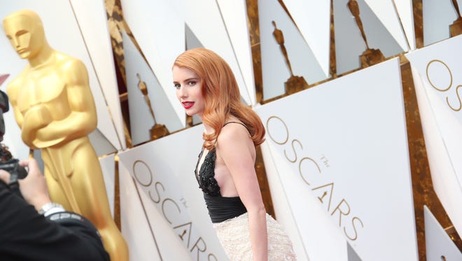 Emma Roberts' red hair and old Hollywood glam lit up the Oscars.