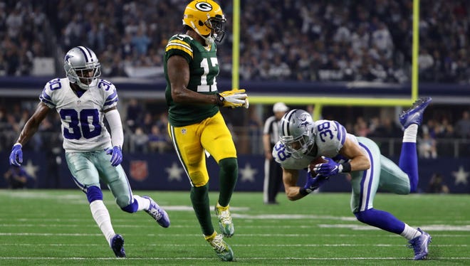 Cowboys safety Jeff Heath (38) intercepts Aaron Rodgers' pass in the second half.