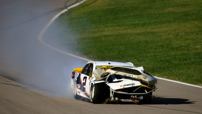 Round 2: Brad Keselowski drives his mangled No. 2 Ford down pit road after spinning into the grass, Oct. 16 at Kansas Speedway. Keselowski finished 38th and dropped to 11th in the Chase for the Sprint Cup standings.