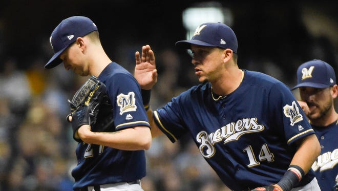 Brewers pitcher Zach Davies gets a pat on the back from shortstop Hernan Perez during his strong start.