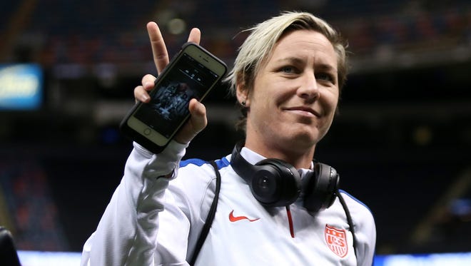 Wambach waves to the fans as she takes the field for warm-ups.