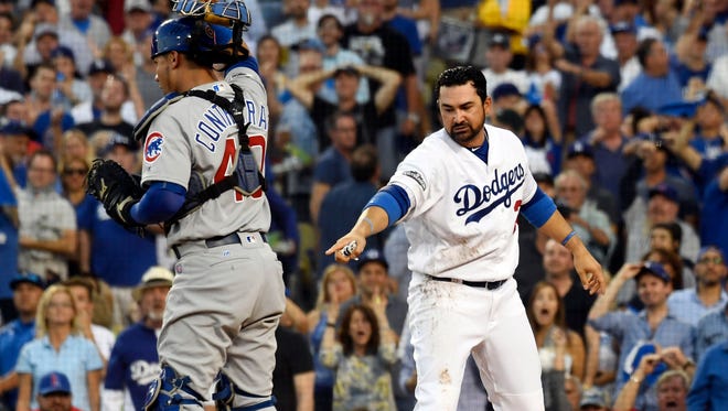 Adrian Gonzalez calls for a replay on a play at home.