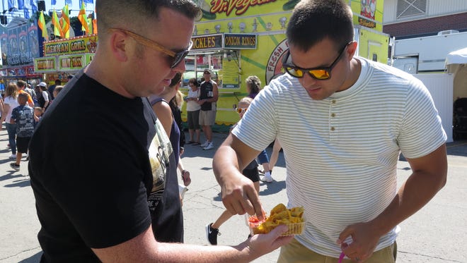 Steve Janetski (left) and Jordan Mikkelsen (right) share an order of cricket nachos.