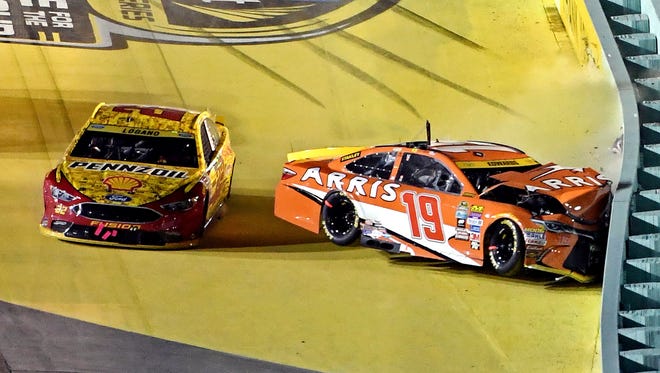 Chase finale: Joey Logano, left, narrowly avoids crashing with Carl Edwards late in the race. Logano finished fourth, while the wreck knocked Edwards out of the race and out of championship contention.