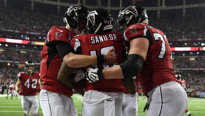 Atlanta Falcons wide receiver Mohamed Sanu (12) celebrates with teammates after a touchdown catch against the Seattle Seahawks during the fourth quarter in the NFC Divisional playoff at Georgia Dome.