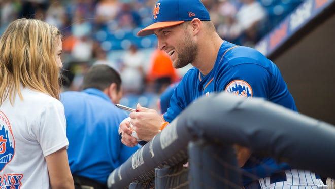 Tim Tebow signs a ball for Mackenzie Demers, 12, of Port St. Lucie, before the New York Mets played the Boston Red Sox on Wednesday, March 8, 2017, at First Data Field in Port St. Lucie. "It was very cool to meet him," said Demers, who was the Make-A-Wish honorary coach for the game. Demers also got a birthday card signed for her school principal who is a Tim Tebow fan.