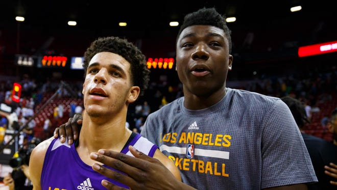 Los Angeles Lakers guard Lonzo Ball (left) celebrates with center Thomas Bryant after defeating the Brooklyn Nets.