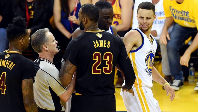 Golden State Warriors guard Stephen Curry (30) and Cleveland Cavaliers forward LeBron James (23) argue during the second quarter in Game 7.