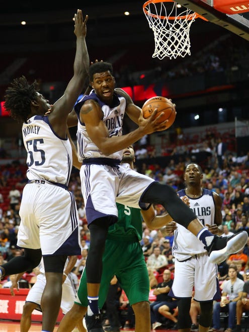 Dallas Mavericks guard Carrick Felix grabs a rebound in the first half against the Boston Celtics.