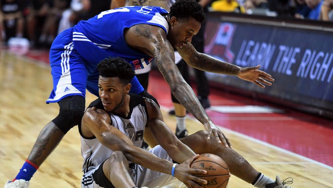 San Antonio Spurs Jaron Blossomgame (15) protects the ball from Philadelphia 76ers forward Isaiah Miles (41) during the second half at Thomas & Mack Center.