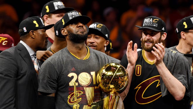 Cleveland Cavaliers forward LeBron James (23) celebrates with the Larry O'Brien Championship Trophy after beating the Golden State Warriors in Game 7.