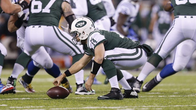 New York Jets quarterback Ryan Fitzpatrick (14) bobbles the snap on the first play of their second drive during the first quarter against the Indianapolis Colts at MetLife Stadium in East Rutherford, N.J., on Monday, Dec. 5, 2016.