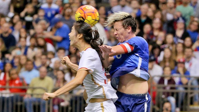 Wambach vies for a header against China midfielder Yang Man during the first half.