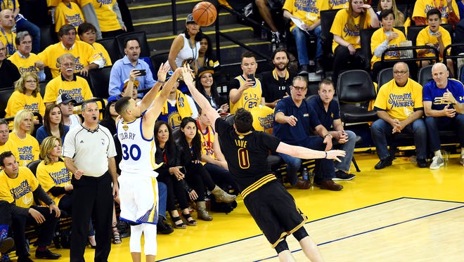 Golden State Warriors guard Stephen Curry (30) shoots the ball against Cleveland Cavaliers forward Kevin Love (0) during the second quarter in Game 5 of the NBA Finals at Oracle Arena.