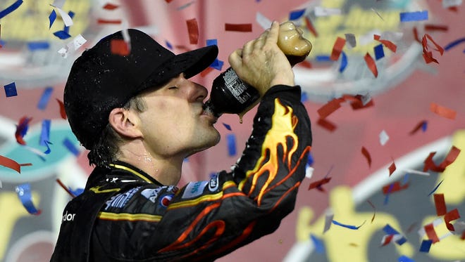 Jeff Gordon celebrates with a Pepsi in victory lane after winning the 5-Hour Energy 400 at Kansas Speedway on May 10, 2014.